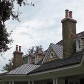 European Copper Pots on 5 chimneys. We designed, fabricated and installed custom copper flashing with 7 European Copper Pots for a luxury residence in 