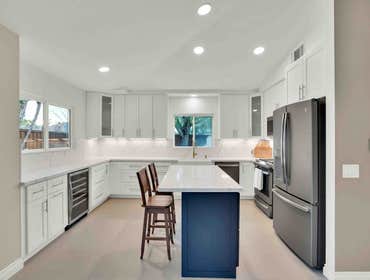 Kitchen Remodel - Oceanside Our team installed stunning new cabinets with under cabinet lights, a gorgeous quartz countertop, and a full backsplash tha