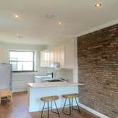 Upper West Side Our work for this project included full gut renovation with exposed brick wall, Calacatta countertop, and glass shower. Bathroom with c