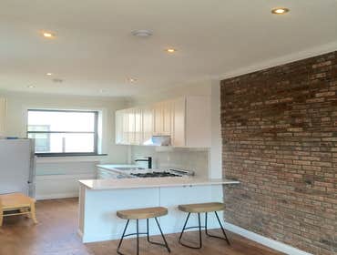 Upper West Side Our work for this project included full gut renovation with exposed brick wall, Calacatta countertop, and glass shower. Bathroom with c