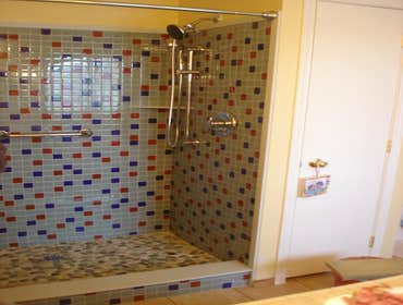 full glass shower w/ pebbles
