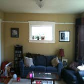 Shamburg Heating LLC Project Before and after a fireplace installation with mantle and cabinets.