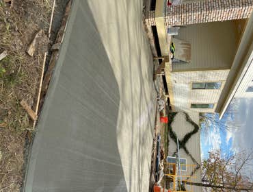Photos by Fma Builders LLC #2 1,300 sqft driveway demo and pour back on the same day. Light broomed driveway