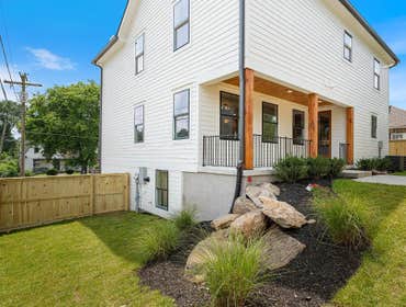 Private fenced backyard at 1135 Delmas Ave, East Nashville: covered patio, fresh landscape, and low maintenance design by CJMC Build.