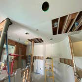 Photos by Interior Art Drywall Inc #1 Hang the walls on ceiling and walls . I just let the open on ceiling where plumbers were pending to fix the pipes