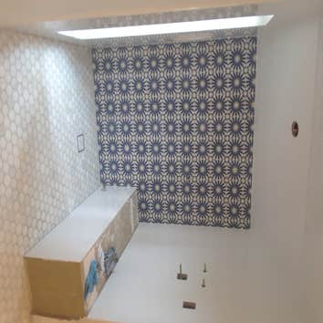 steam shower, cement accent tile on back walls, ceramic wall tile on side walls and celling, marble hexagon on floor.