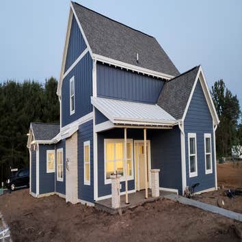 New Home CertainTeed Landmark pewter colored Shingles.
McElroy 16inch White 26ga snap lock standing seam.