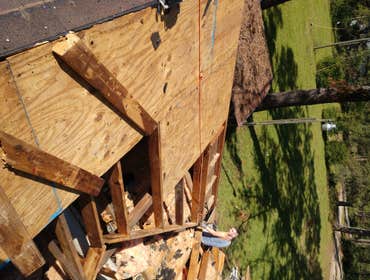 Photos by Service Restoration Pros LLC #1 A tree fell through the roof of this 3 bedroom house during Hurricane Ida. It left several gaping holes and a