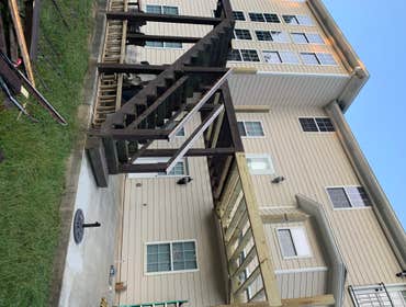 Photos by JNB Development Deck remodel with modern metal piping and weather resistant composite decking