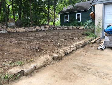Residential Backyard Landscape Renovation Excavation, grading and leveling of this residential backyard space, including install of a custom stone reta