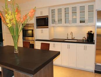 Kitchen remodeling in Woodland Hills Complete kitchen remodeling in Los Angeles with White cabinets, that part of the top cabinets have tinted glass wi