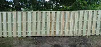 Minnewawa good neighbor fence. Treated wood good neighbor fence on property line.