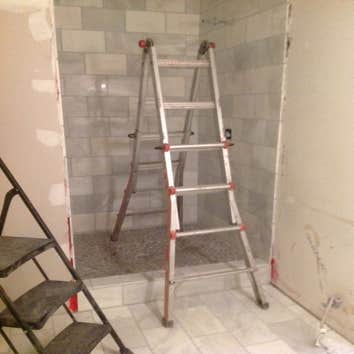 Small bath remodel The color scream on this one turned out great. Carrara marble & porcelain wood plank floor & bench seat. Black Stone vertical center