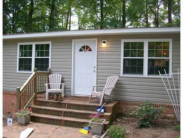 Siding This home was completely made over with an upgrade in siding and replacement vinyl windows.