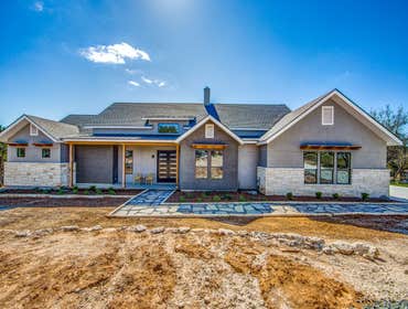Texas Stone and Stucco Ranch Residence This home is nestled on a gently sloping lot and sited to frame a magnificent hill country view. Plentiful windo