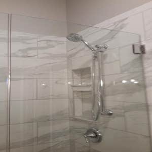 Photos by Custom Kitchen and Bath Works, Inc. #1 Two bathroom remodeling project.
Master bathroom shower, tile floor, and wood trim.
Hall...