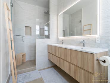 Photos by O.T Bay Builders-Master Bathroom Walk in Shower Revamping our client's master walk-in shower with stunning white stone-like tile that extends