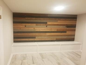 Custom storage bench with wooden panel accent wall