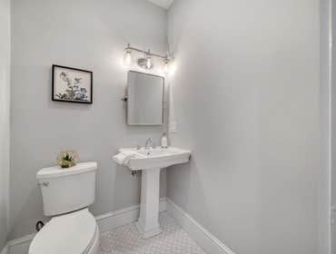 Photos by LCG BOSTON LLC #1 Full Home Remodel. Bathroom with custom glass, kitchen remodel with a beautiful exposed brick.