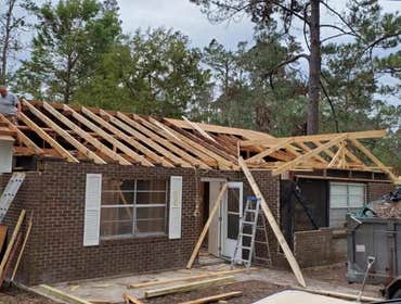 Photos by Service Restoration Pros LLC #1 A tree fell through the roof of this 3 bedroom house during Hurricane Ida. It left several gaping holes and a