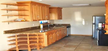 kitchen Kitchen remodel including cabinets, counters, custom shelves, and flooring and custom stairs