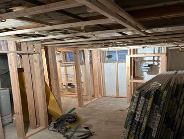 Photos by Your Expendable Services LLC #1 Basement remodeling project completed with new framework, walls placed and painted. New recess lights and LPV