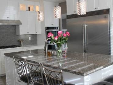 Photos by Eco Design & Builders Inc #10 Custom kitchen cabinets with a big island with sink.
Granite counter top with stone backsplash.
Upper cabinets 