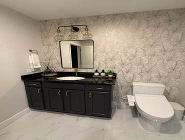 Chic Bathroom Renovation Reimagined the bathroom with a sleek, modern design and top-of-the-line finishes for a truly refined look.