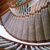 Custom Runners Custom runner installed on a winding stair case, and back set of steps with angled landings.