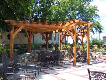 (2) Custom designed timber-framed pergola, timber-framed carport Each timber is hand carved to fit into the joining beam.