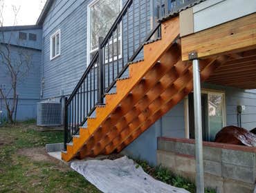 Project Rita Replaced existing deck, upgraded materials, added a staircase, concrete pad and railing around the balcony area.