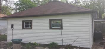 New roof and siding in Oak Park Our company replaced shingles on this garage. Also we installed new siding, soffit and fascia.