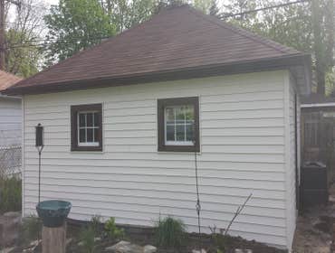 New roof and siding in Oak Park Our company replaced shingles on this garage. Also we installed new siding, soffit and fascia.