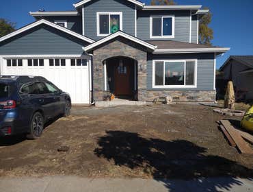 Photos by Subias Granite & Marble #2 Stacked stone outside front of house with arch.