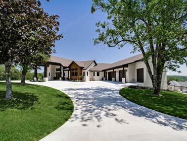 Lakehouse 4400 sq. feet all on one floor in main house, 1600 sq. feet in guest house. 8 car garage. Sitting on 4 acres overlooking the lake.