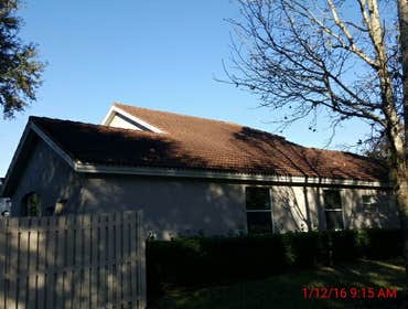 Photos from Popa Construction LLC Before & Afters of a soft wash roof cleaning and driveway and side walk cleaning.