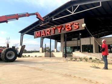 Exposed bulb channel letters on backer for Marty B's