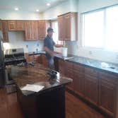 Belinda's kitchen remodel We knocked down the wall between the living room and kitchen to make this large open area with new flooring, cabinets and gra