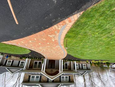 Photos by Madlandscape #4 Beautiful brick driveway with black accents on the sides . Mulch beds on both sides of the driveway with plants and trees . p