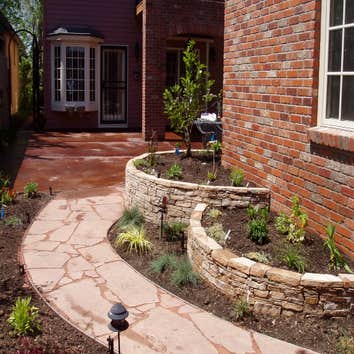 Photo(s) from Integrity Design & Landscape Inc Flagstone wall and pathway