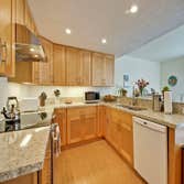 Mid Century Modern Kitchen Design This custom kitchen remodel is all about wow from the moment you walk in. It features a bold waterfall island with wa