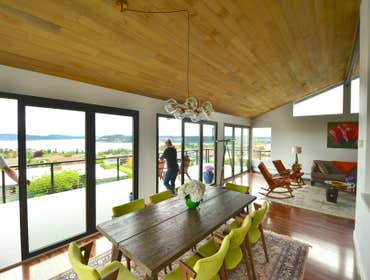 Opening Up the View Reconfiguring the view elevation to open entirely with a series of full width folding doors to a rebuilt terrace. Below, a patio, 