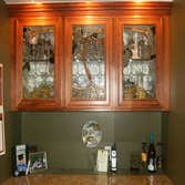Make your wet bar a work of art! This bar has a grape vine coming from the center window and trellising to each side.