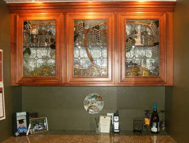 Make your wet bar a work of art! This bar has a grape vine coming from the center window and trellising to each side.