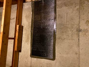 Foundation wall crack repaired with carbon fiber