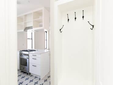View from entry to kitchen, showing custom coat rack