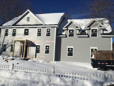 Silk Lane Construction of a colonial style home with an attached garage.