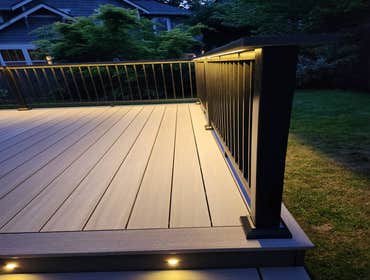 Modern PVC Deck with Integrated LED Stair Lighting This premium low-maintenance deck was built using TimberTech Advanced PVC decking in Coastline with 