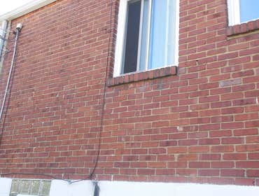 Project photos from Hollis Contracting We pressure washed the front of the house to clean it and removed the existing paint on the foundation in order 