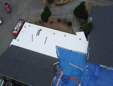 Isaac Roof Construction Commercial Roof Project Flat roof replacement with a minimum R-value of R-30 and a Class A Fire rating.